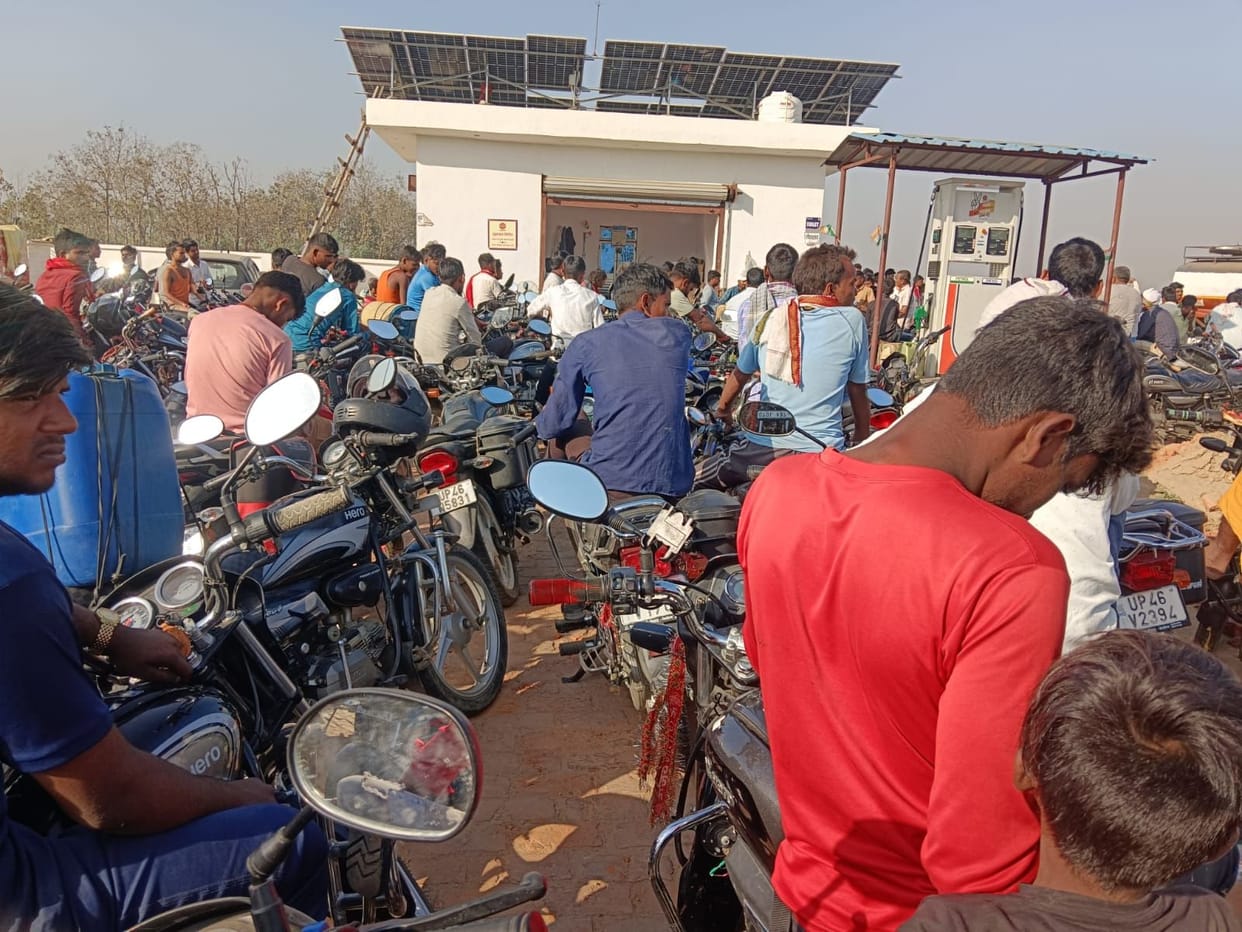 People standing in queues in the scorching heat