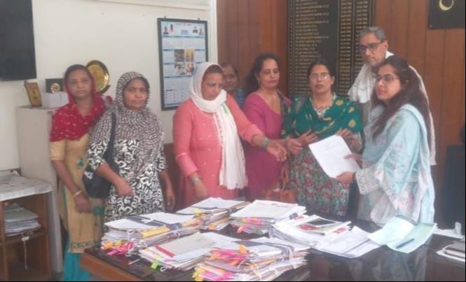 Anganwadi workers and helpers staged a sit-in protest to press for their demands.