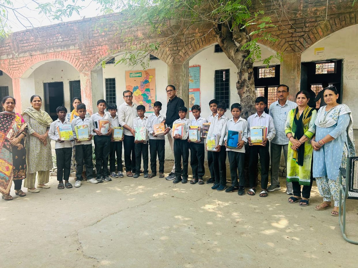 Students' faces light up upon receiving books.
