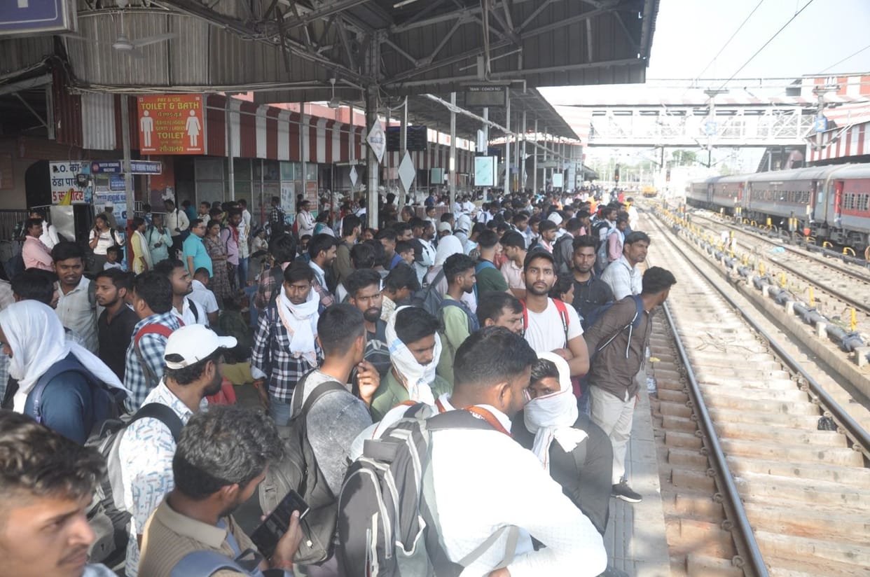 Crowds of candidates throng railway stations.