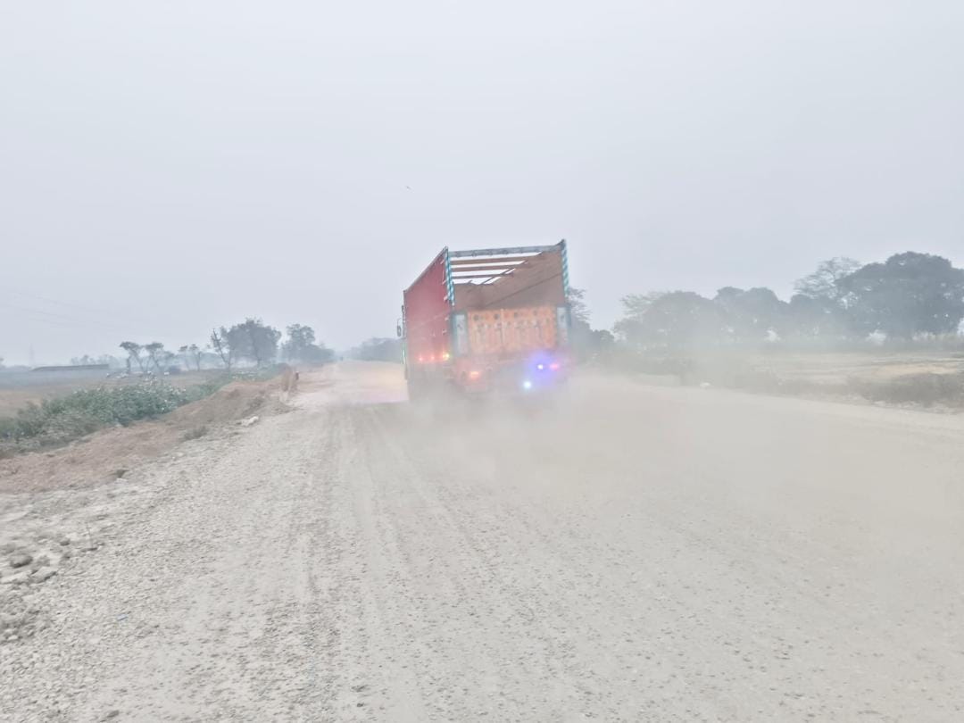 Passersby are troubled by the dust flying on the under-construction highway from Maharajganj to Thuthibari.