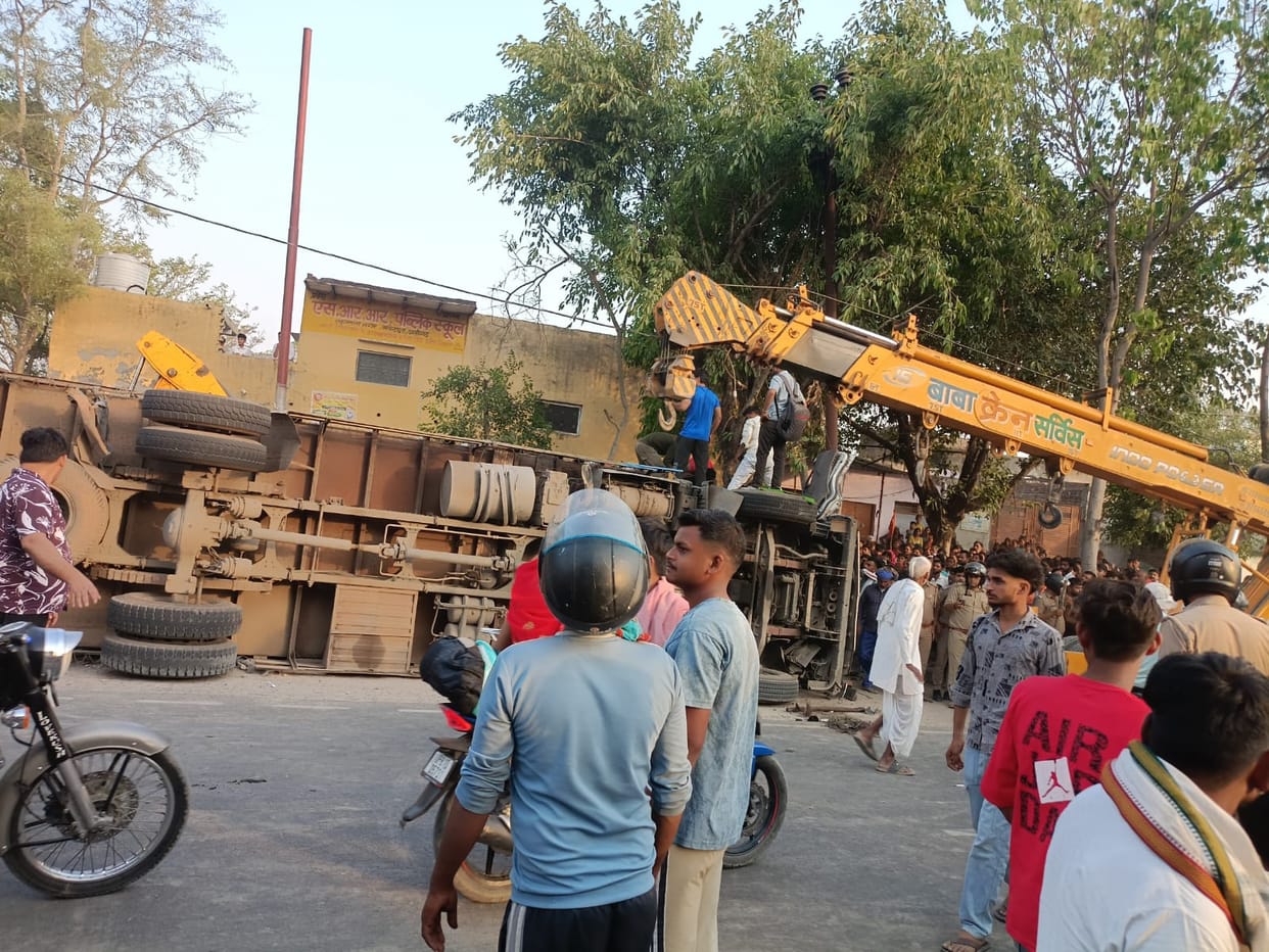 Truck loaded with paper rolls overturns, driver injured