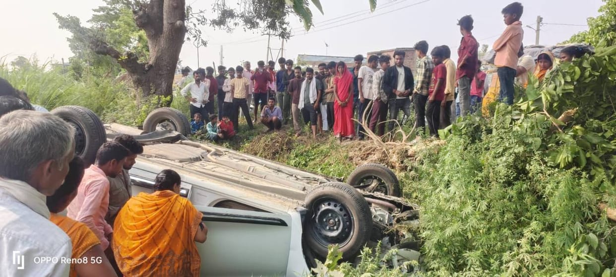 Car Overturns into Ditch After Colliding with Bike; Seven Occupants Safe