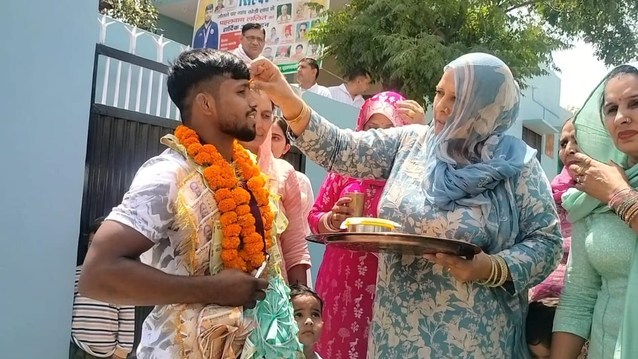 Lalit was welcomed by the villagers after winning the silver medal.