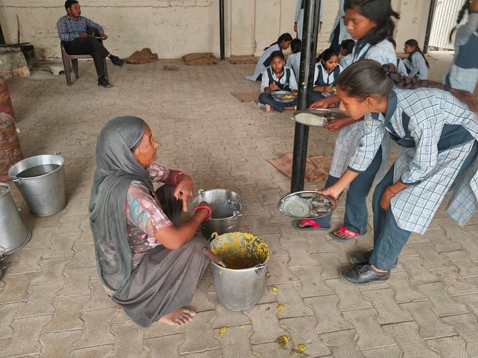 Biscuits are being used for work, while Guruji is providing mid-day meal from his own pocket