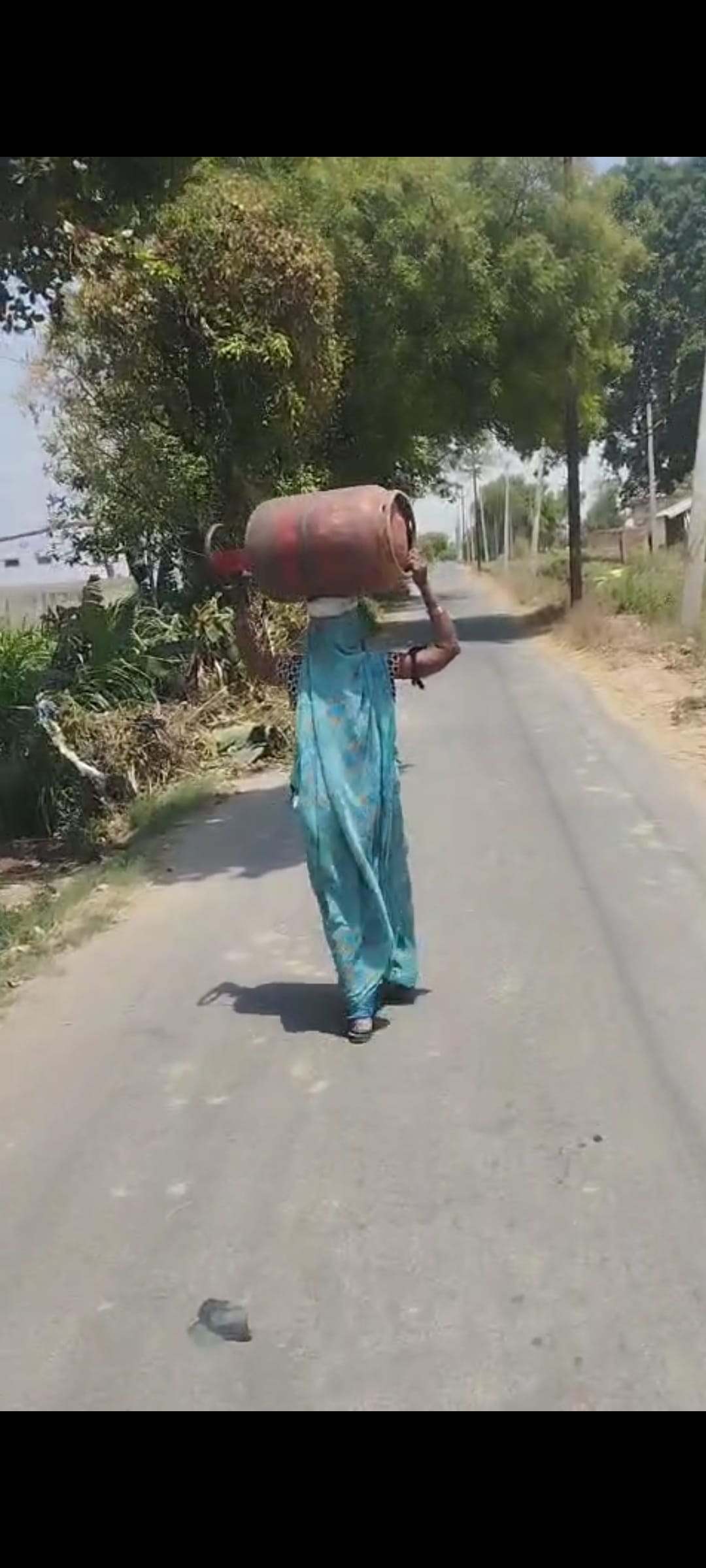 Elderly woman walks 3 km with cylinder on her head to get it refilled