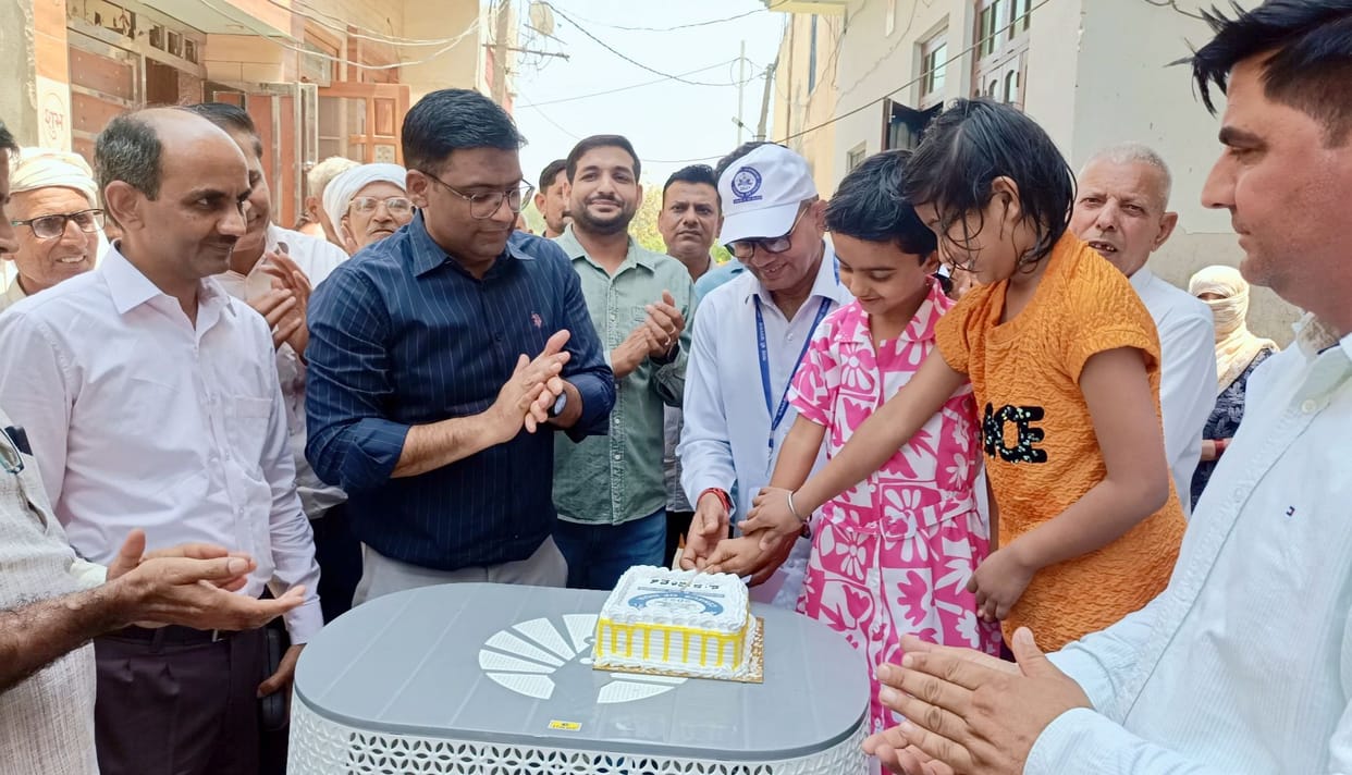 The DC inaugurated the house listing exercise by having young girls cut a cake.