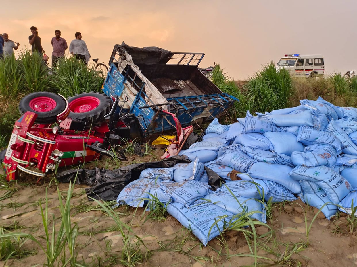 A tractor-trolley loaded with sugar bags overturned in a field, killing the driver and injuring his son.