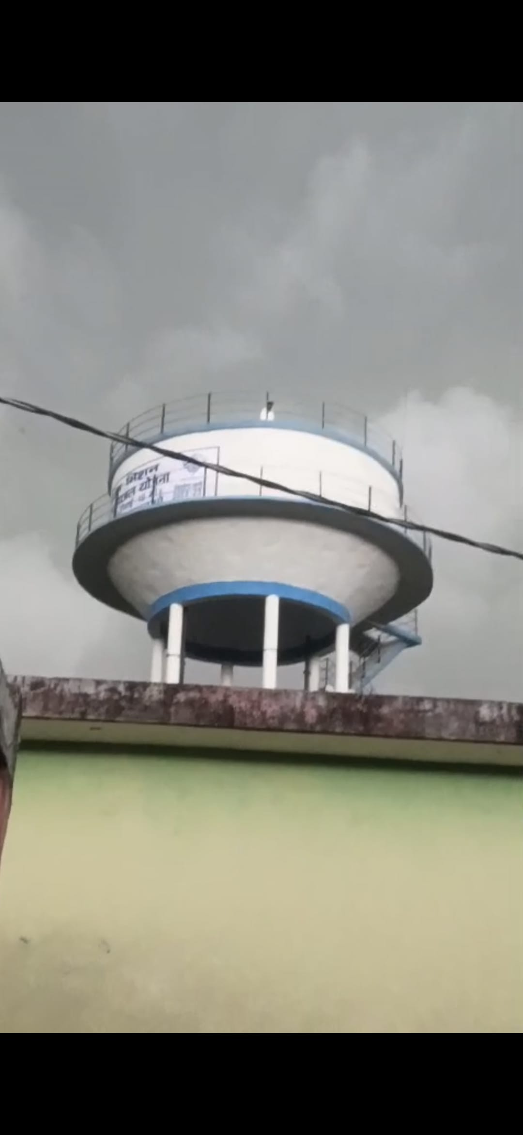 Distraught over a broken relationship, a young man climbed atop a water tank