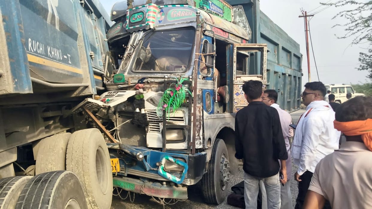 A truck collided with a dumper carrying dust, leaving the driver trapped in the cabin.