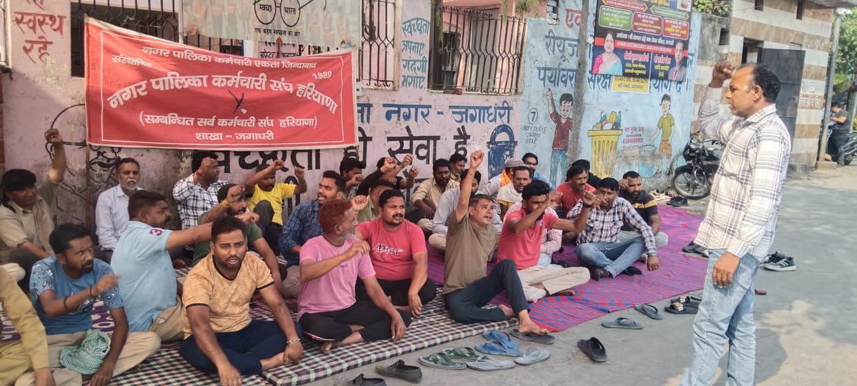 Sanitation workers raise slogans in support of their demands