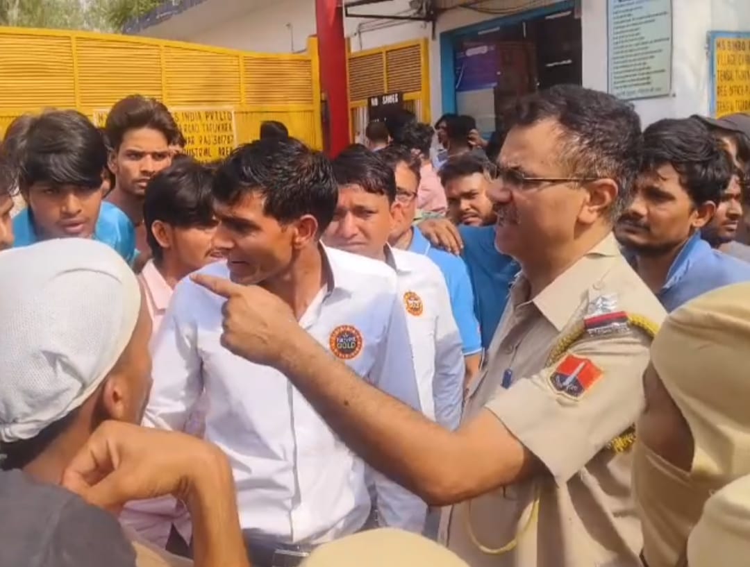 Workers protest outside the company demanding a pay hike