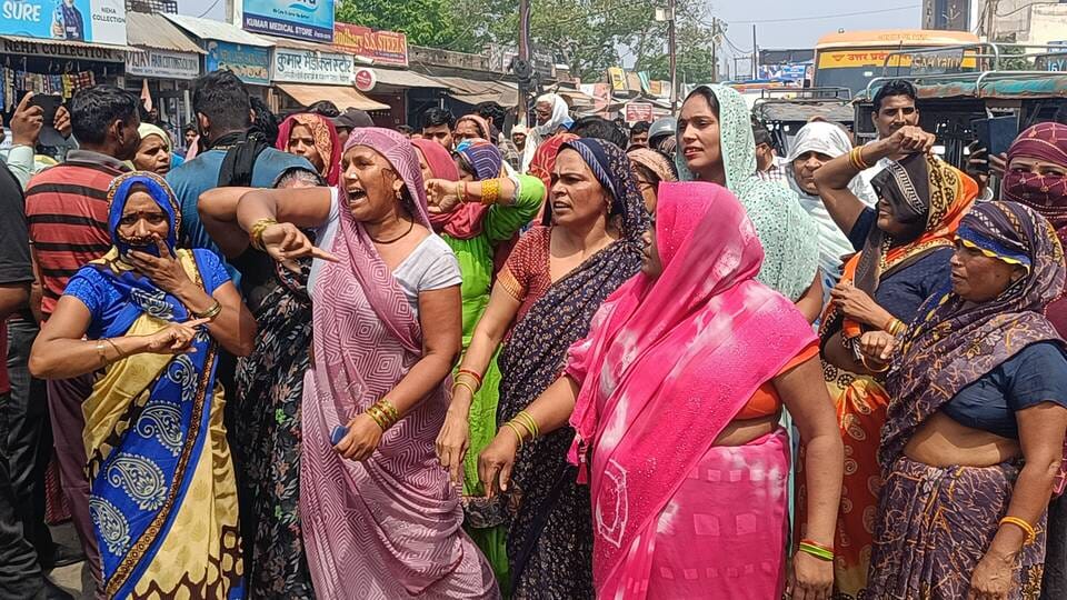 Women take to the streets in protest against smart meters, block traffic.