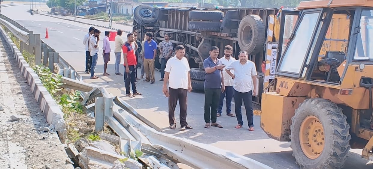 Truck Overturns After Tire Bursts; Driver and Others Have Narrow Escape