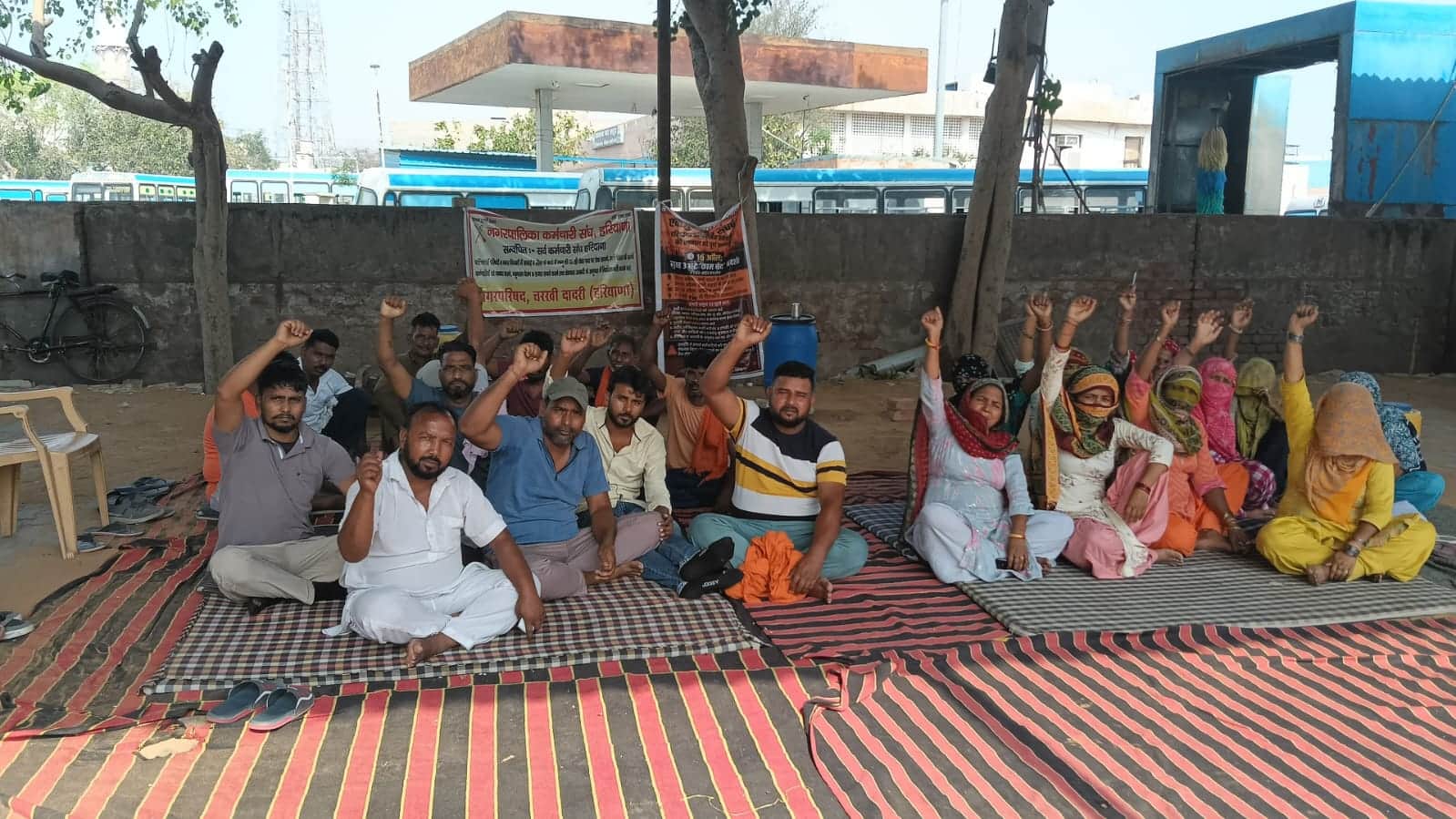 धरने पर बैठे सफाई कर्मचारी नारेबाजी करते हुए। 