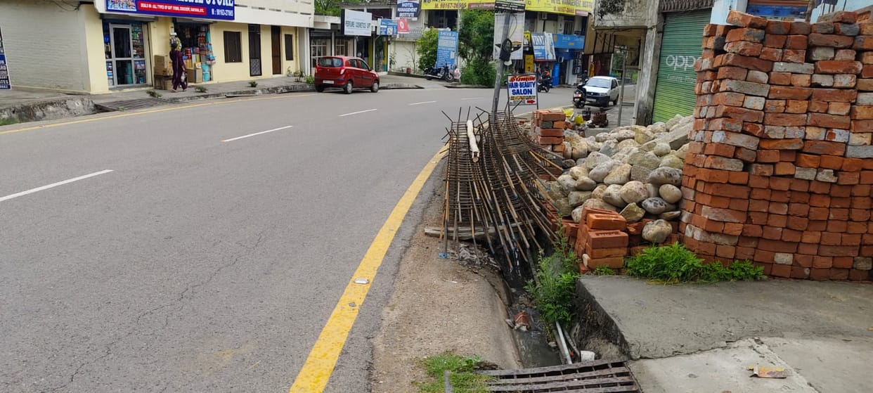 The iron rods kept on the roadside are inviting accidents.