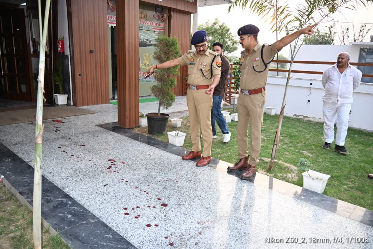 Two friends were shot outside a hotel after being invited for dinner.