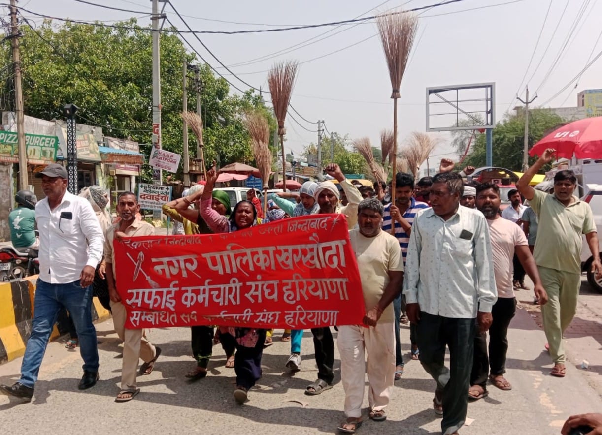 Sanitation workers took out a procession with brooms