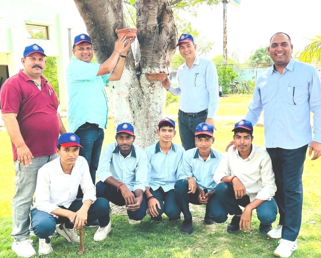 Water vessels for birds hung on trees at Khanda School.