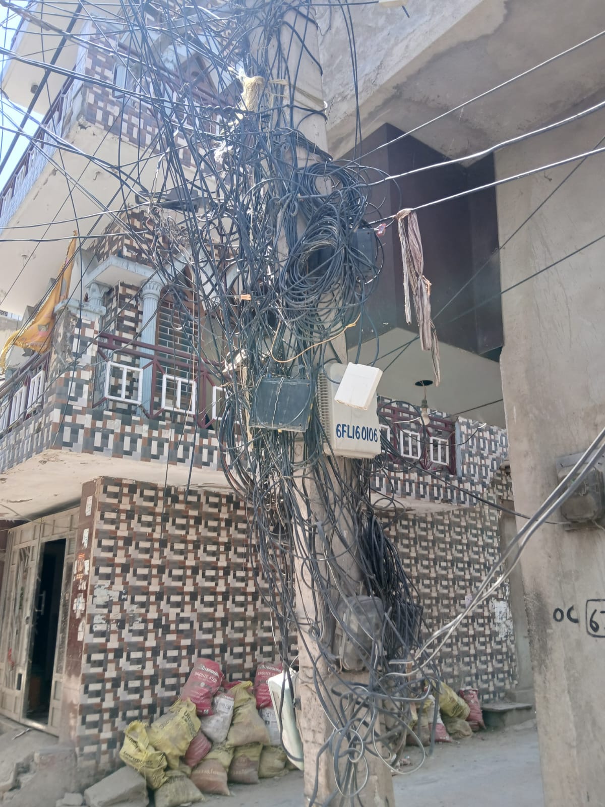 A network of cables and broadband wires stretched across power poles