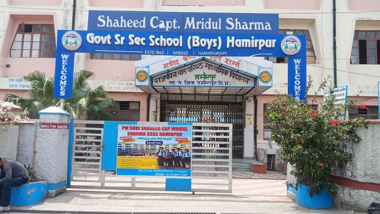 The school's name has been changed in the records, but the old board still stands at the gate.