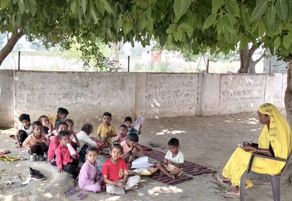 Studying under the shade of trees, reports on mobile phones.