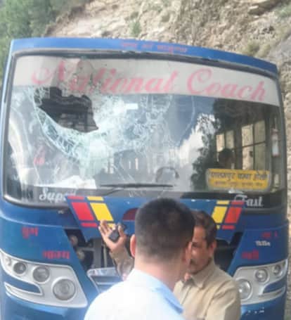 A stone fell from a hill on the windshield of a private bus, causing minor injuries to the driver.