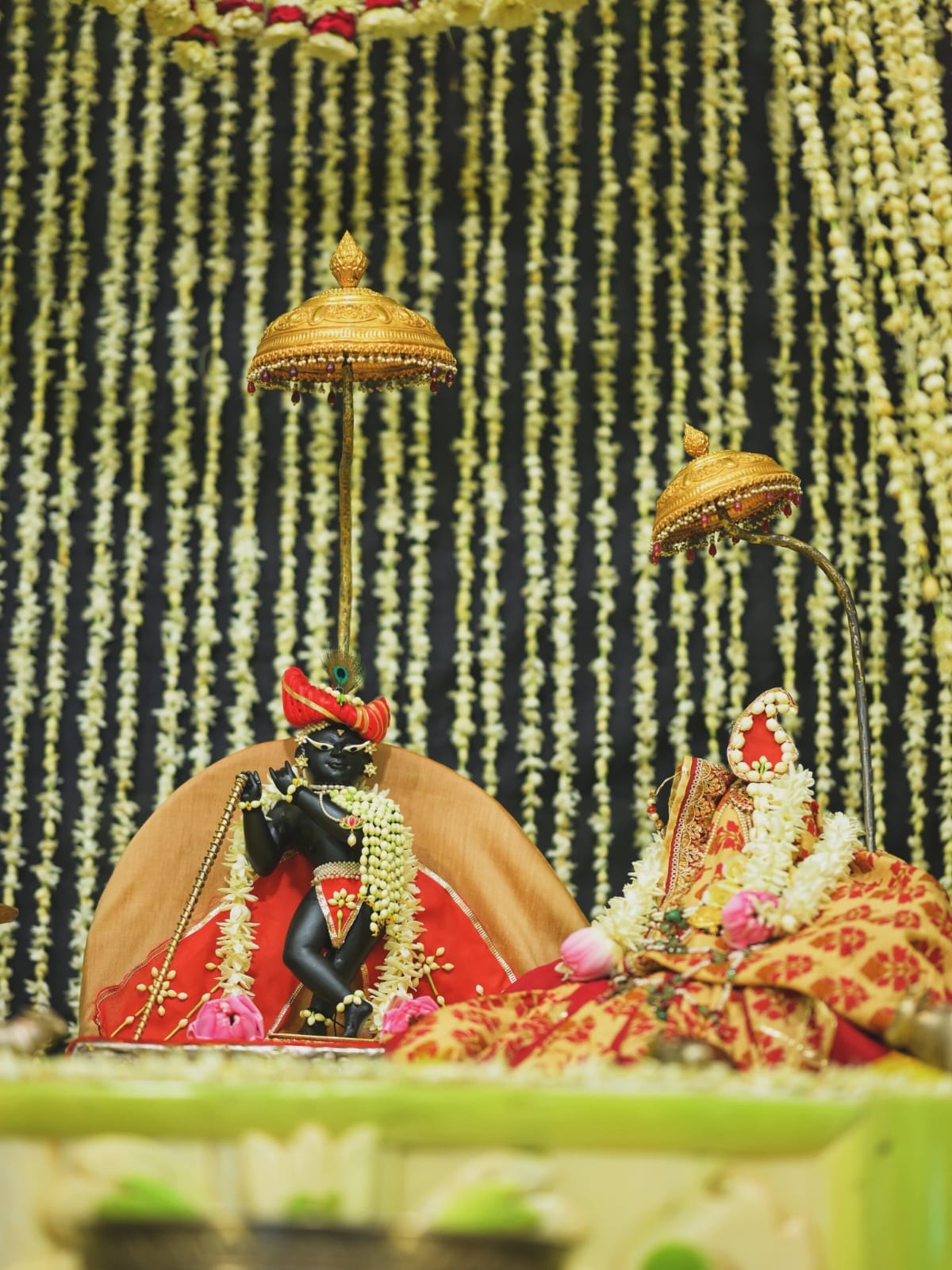 Thakur Radharaman Lal graces a pavilion of flower buds;