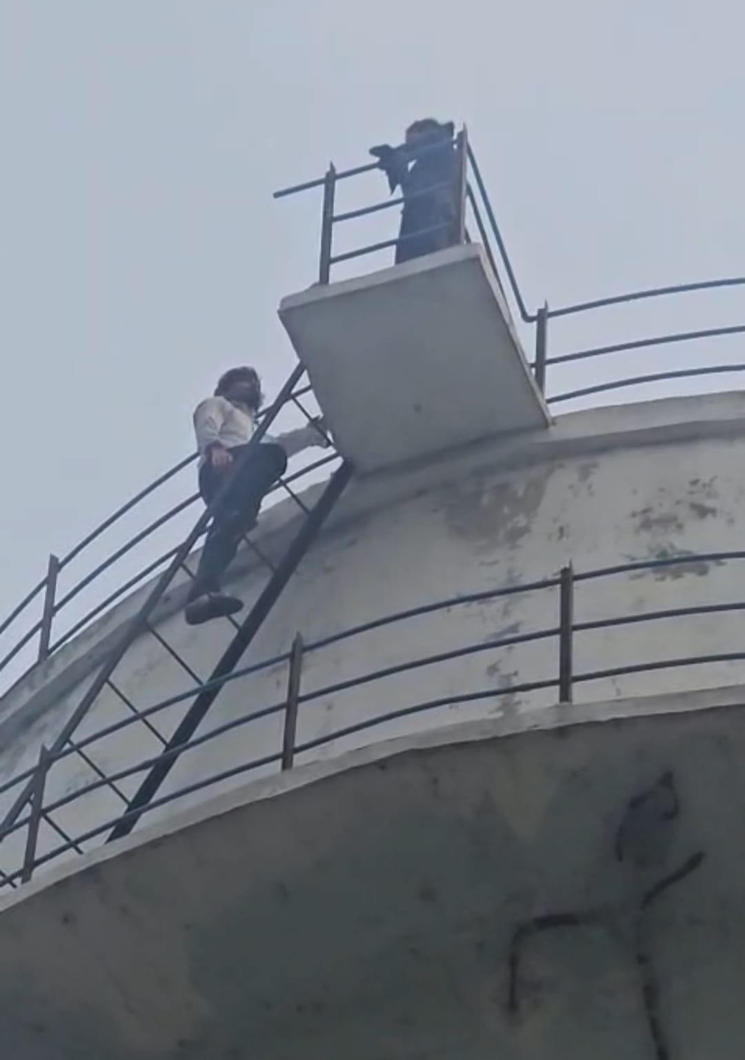 A teenager who climbed an overhead tank in her insistence on marriage was brought down after her lover reassured her.