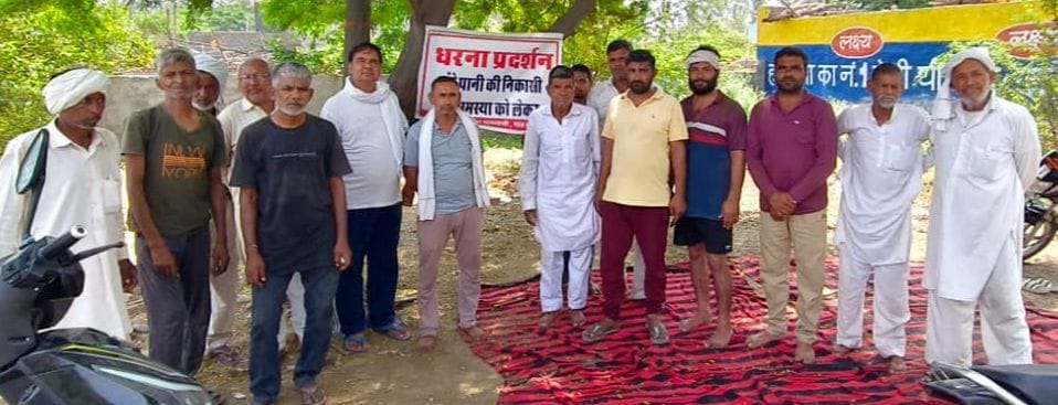 Troubled by waterlogging, villagers take to the streets and stage a sit-in protest.