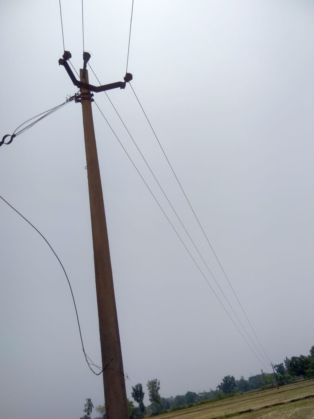 Pole installation work remains incomplete; dangling wires pose a risk of accidents