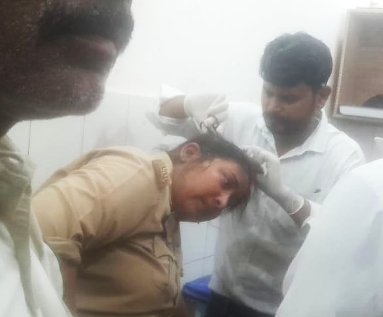 Four people, including a woman constable, were injured when a wall collapsed while removing encroachments.