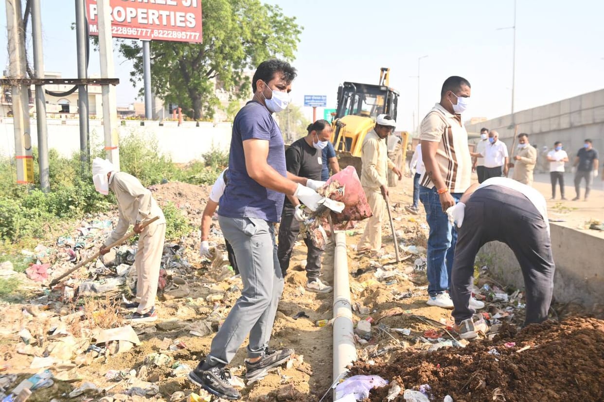 MLA picked up a broom and removed plastic and dirt.
