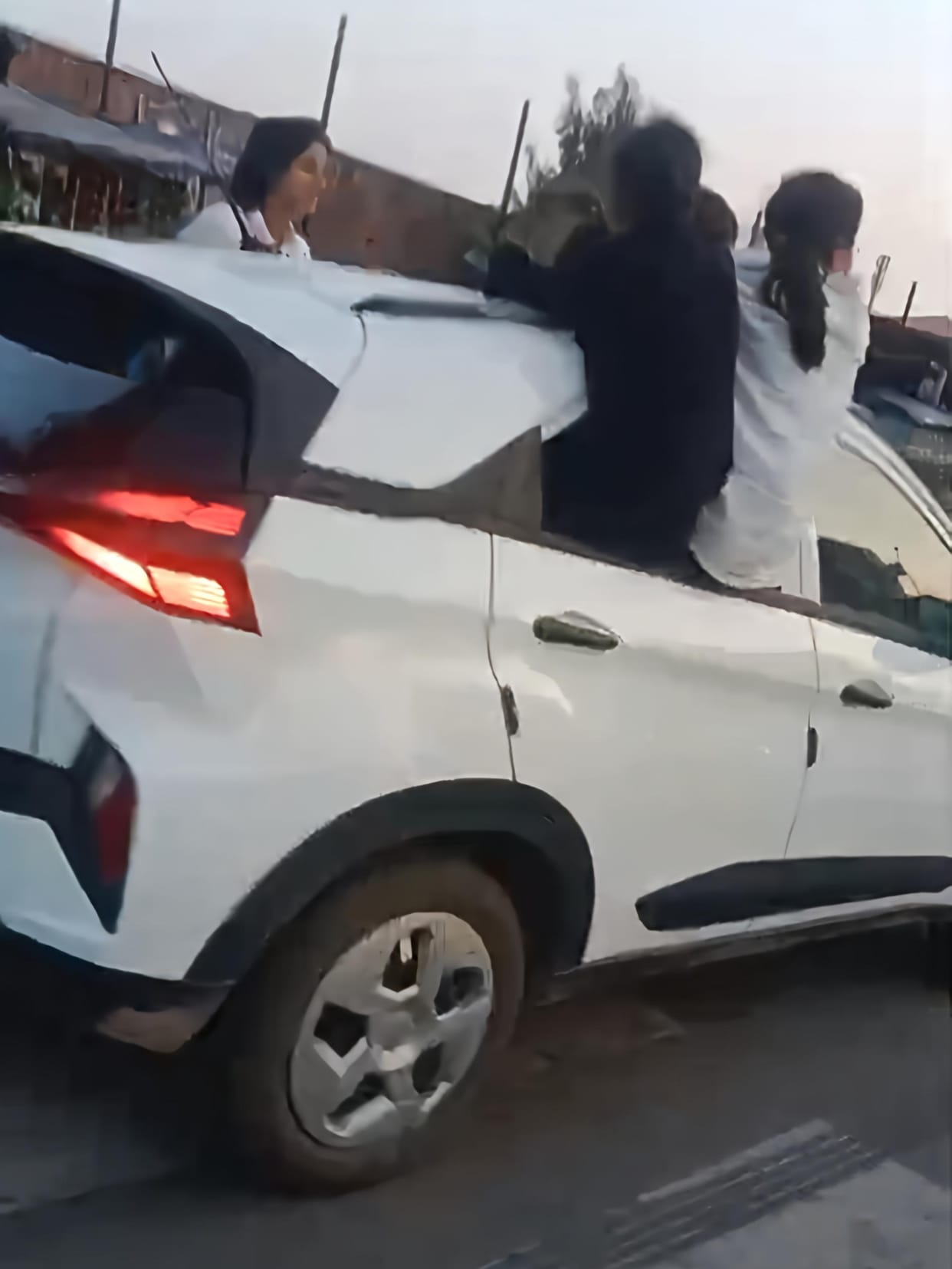 Girls perform stunt by jumping out of moving car windows