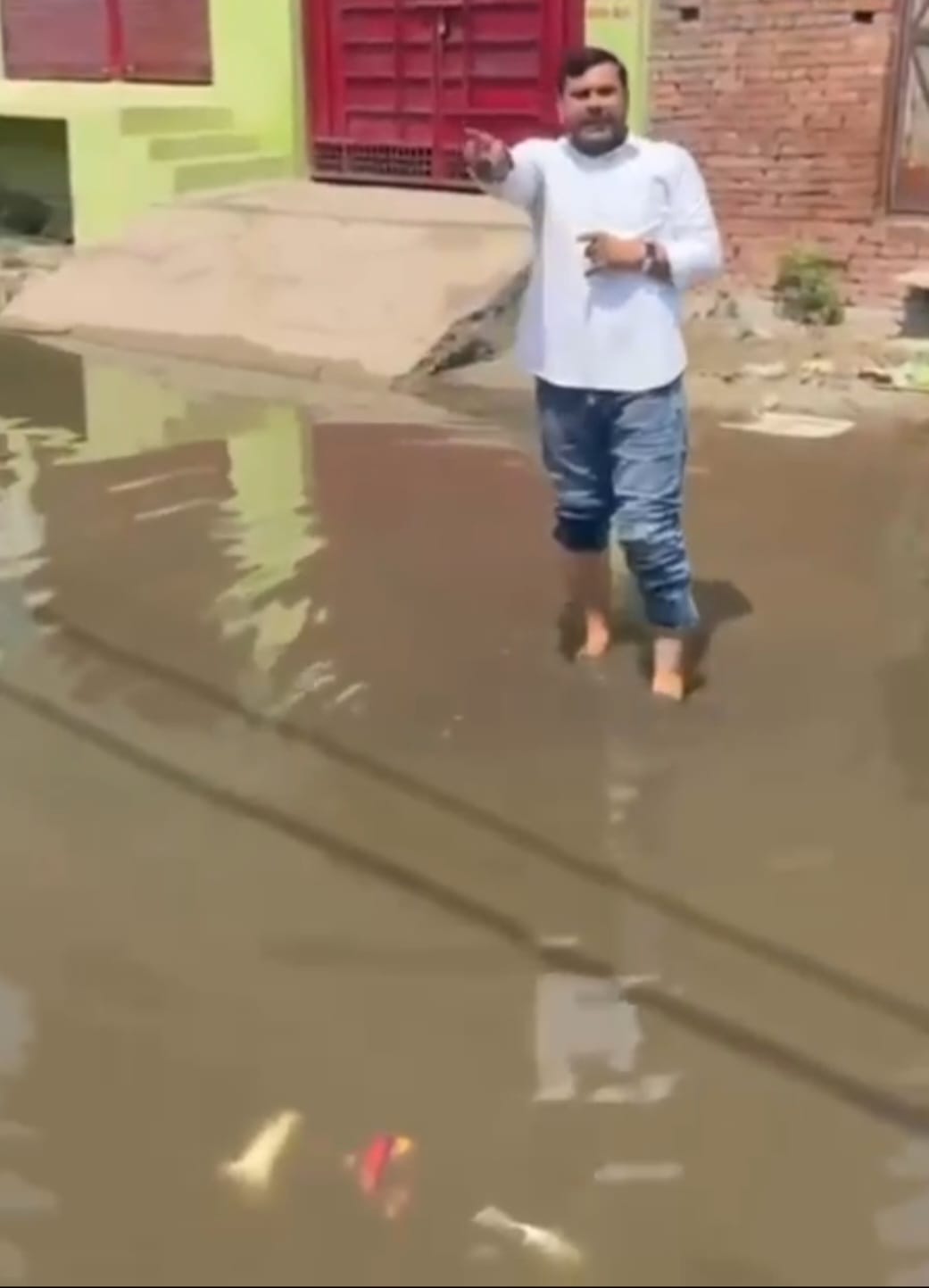 Students walk through contaminated water to reach school
