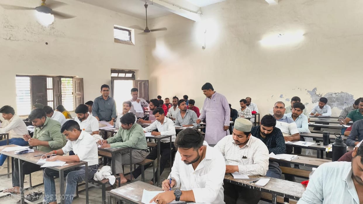 Students were suffering from the heat and took off their shirts to take the exam.