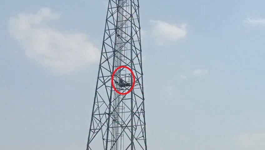 A young man climbed a tower to talk to his girlfriend.