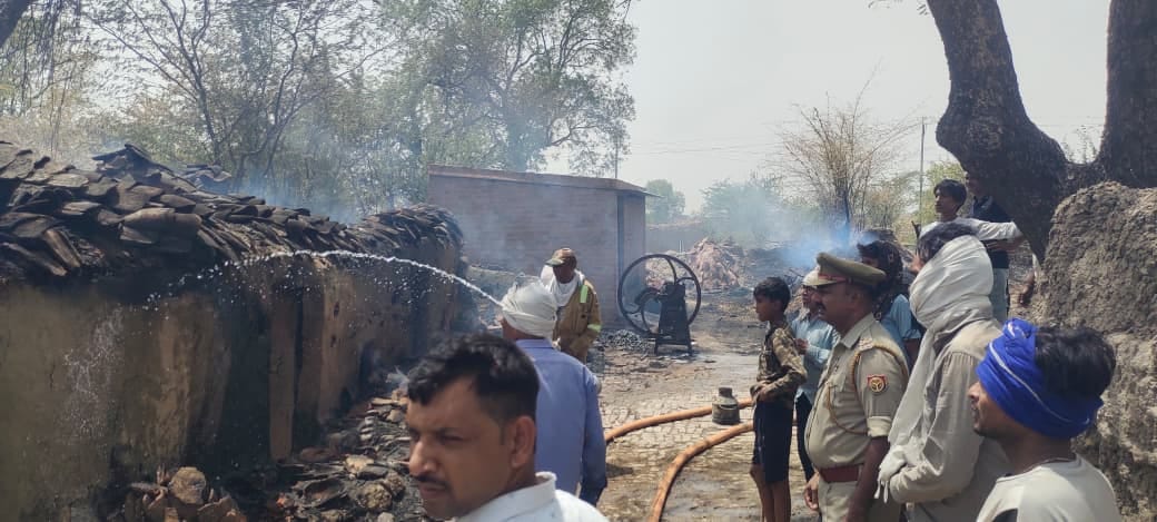 The forest fire reached the settlement, burning three mud houses to ashes.