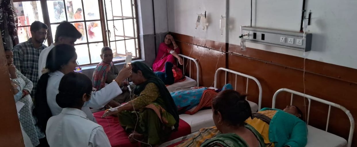 Emergency ward full of diarrhea patients, two patients on one bed