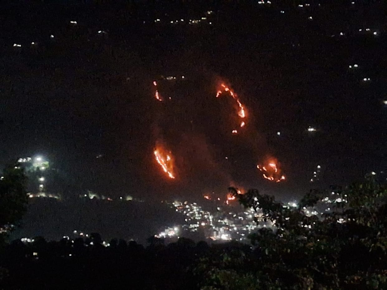 An unknown person set fire to the hill.