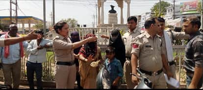 A woman sits with her children at a petrol station in Shivpuri, accusing a Bhim Army leader of molesting her.