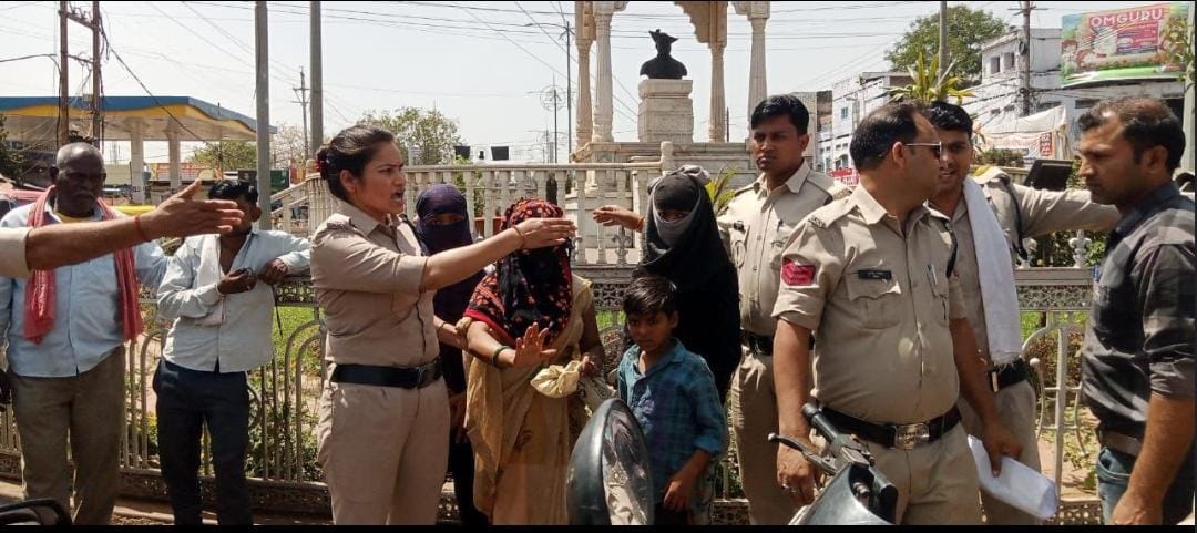A woman sits with her children at a petrol station in Shivpuri, accusing a Bhim Army leader of molesting her.