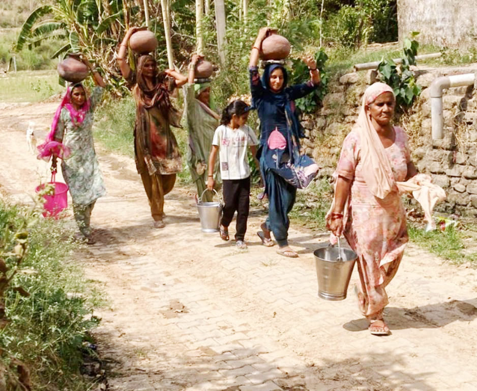 Bringing water in pots on their heads from two kilometers away