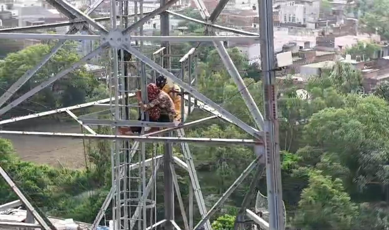 Two women climbed a mobile tower to stay with their boyfriends.