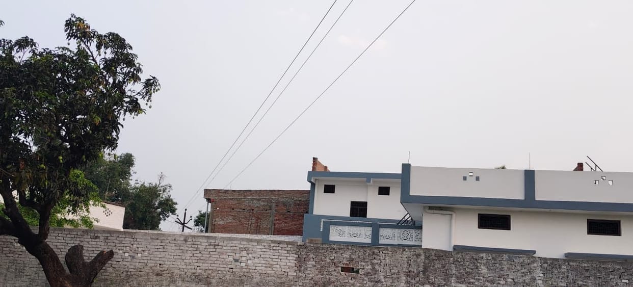 The danger persists... high-tension wires passing over houses in residential areas