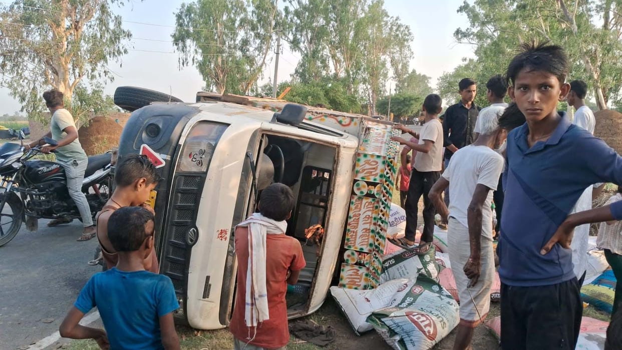 Driver injured as loader overturns, sacks full of animal feed spill onto road