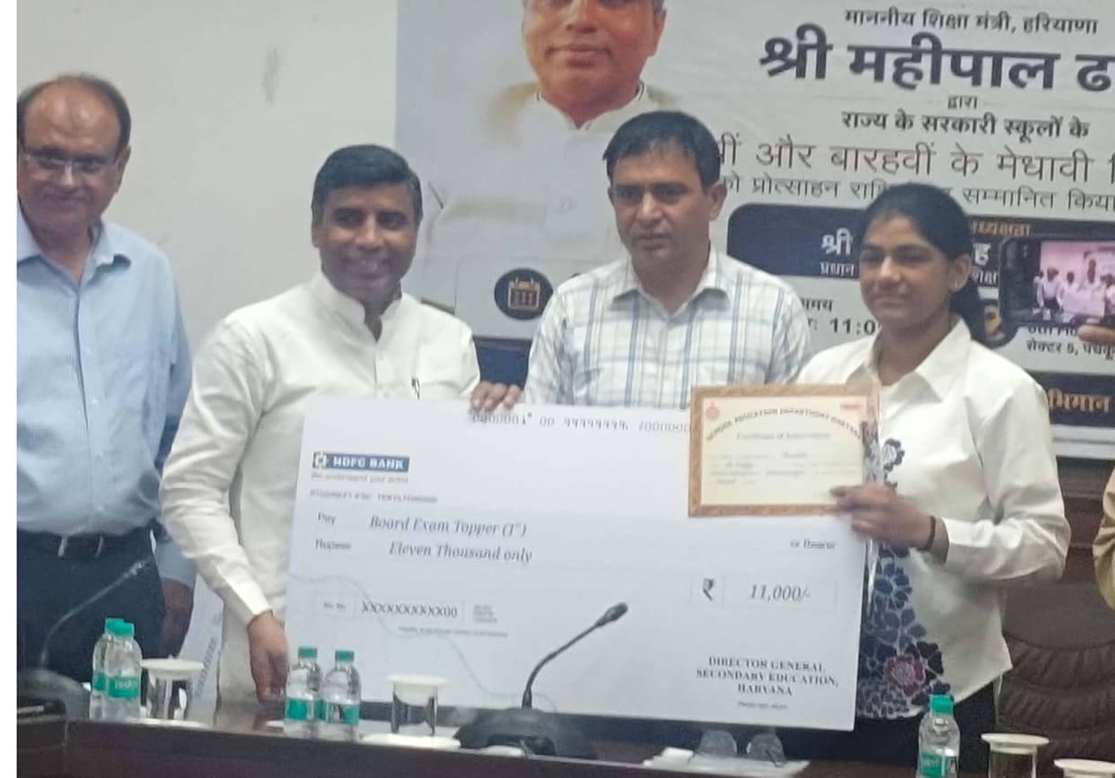 Minister Honors Topper Student
