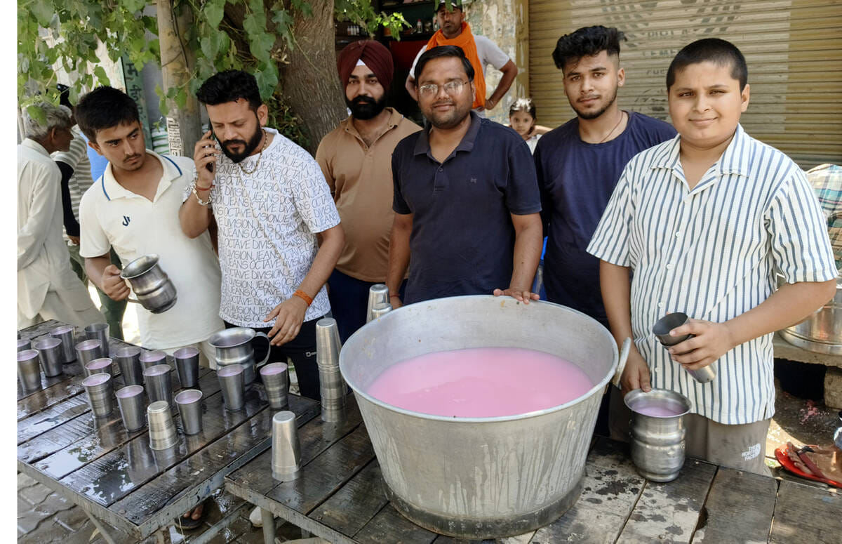 Shopkeepers set up a stall selling cold sweet water on Babain Barada Road.