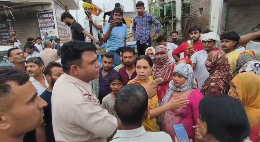 The woman injured in the beating was put on a cot and the road was blocked.