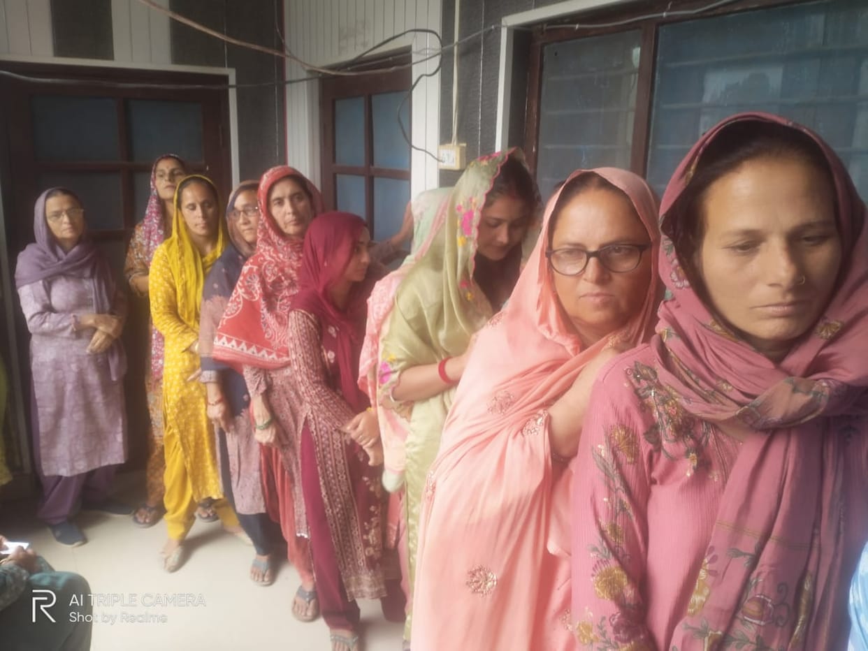 Women left their morning work to cast their votes.